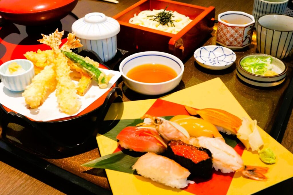 Japanese set meal with sushi and tempura served on a traditional tray