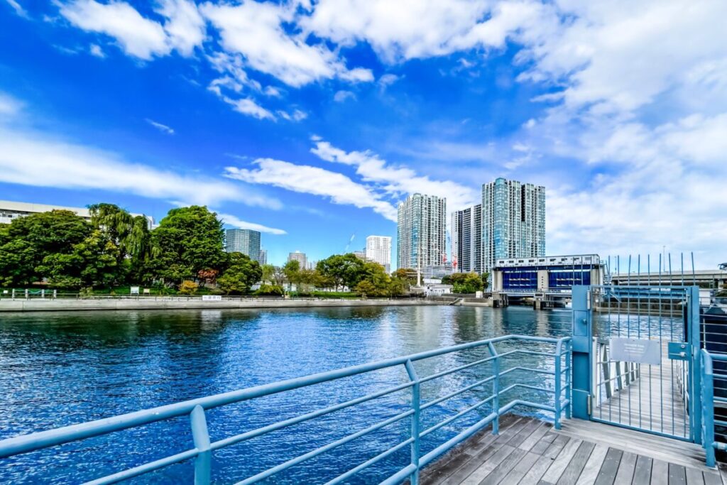 Tennozu Isle water gate with distant Tokyo skyscrapers along the canal