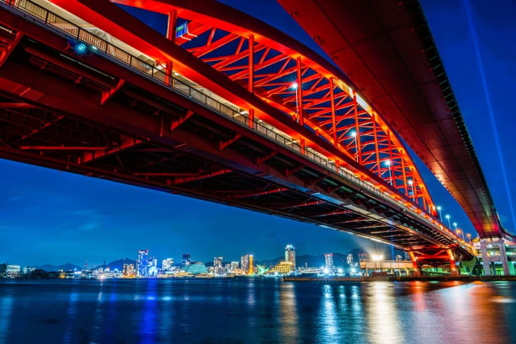Illuminated Kobe Ohashi Bridge glowing over the waterfront at night