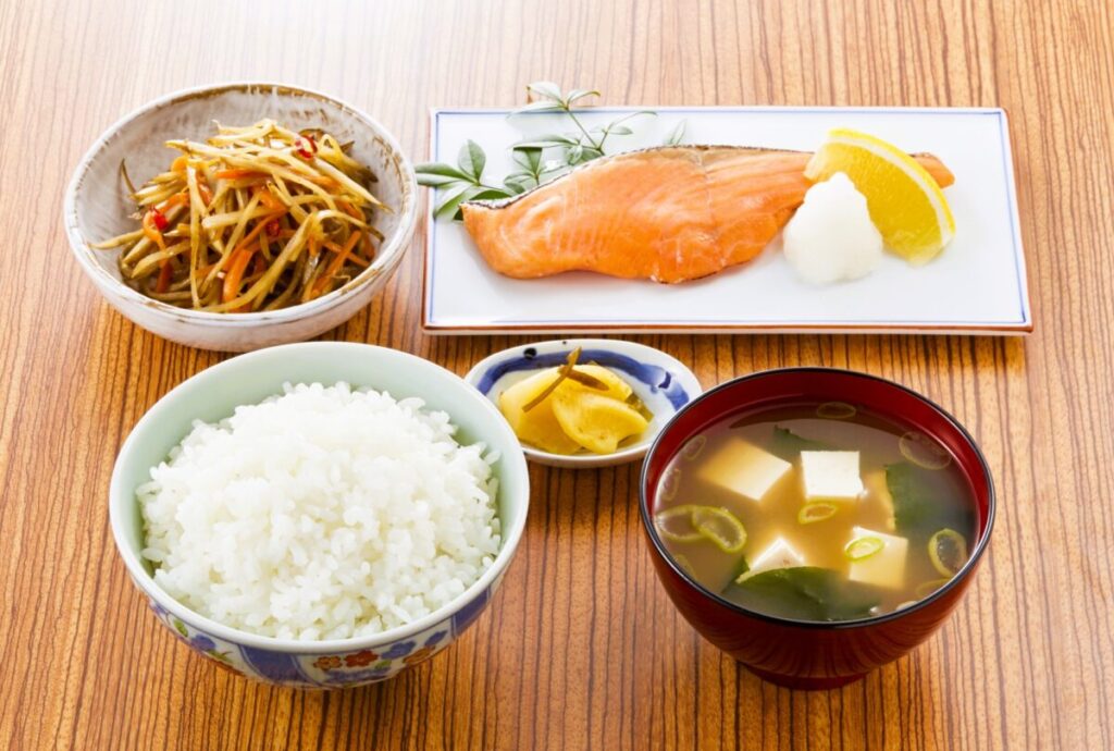Traditional Japanese fish set meal with grilled fish, rice, miso soup, and side dishes