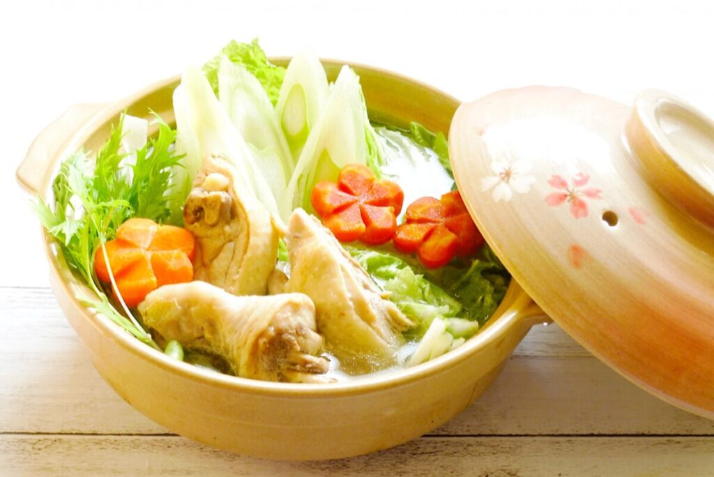 Traditional Hakata-style mizutaki chicken hot pot served with broth and dipping sauce