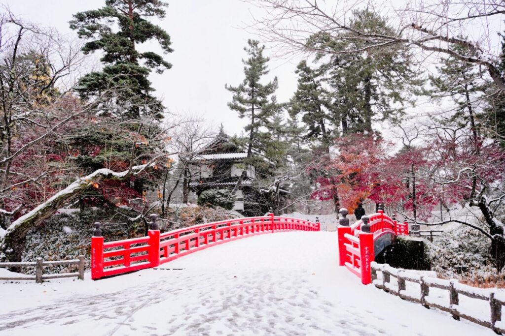 Gojō Bridge at Hirosaki Castle in winter, surrounded by snow and traditional scenery