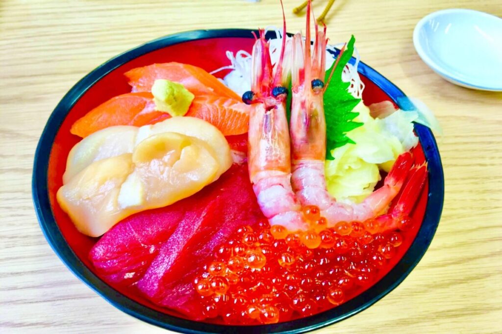 Fresh Hokkaido seafood rice bowl topped with salmon, tuna, scallops, shrimp and salmon roe