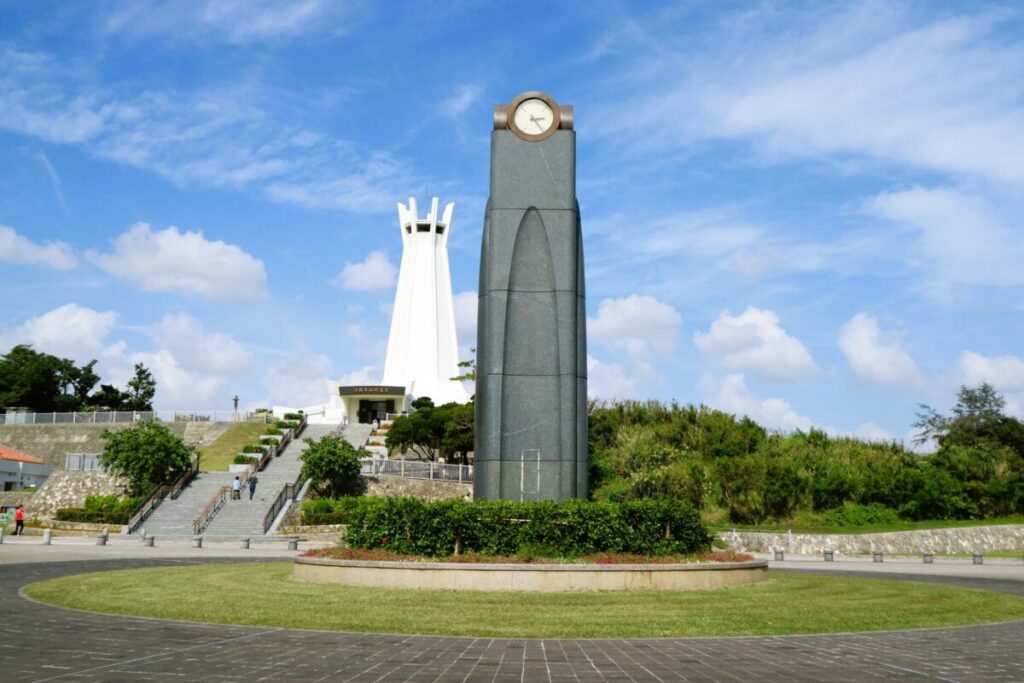 Okinawa Peace Memorial Hall with white monument set against a bright blue sky