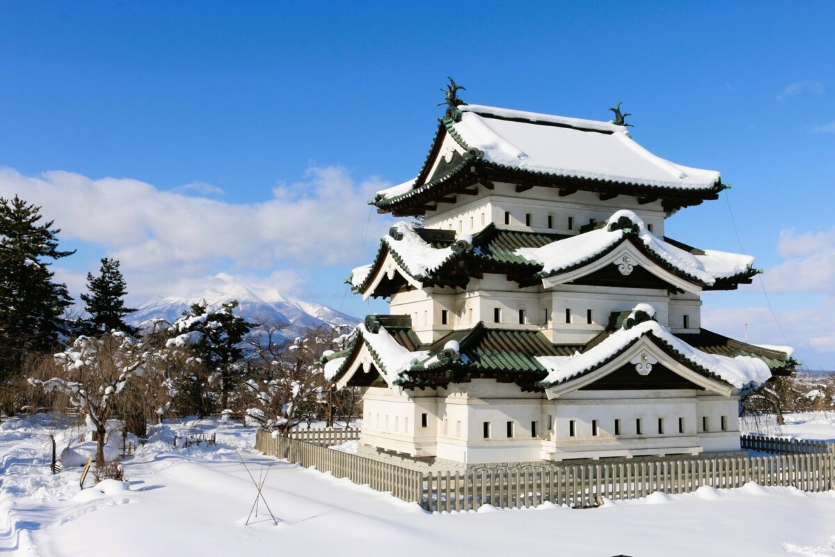 Hirosaki Castle covered in winter snow with historic stone walls