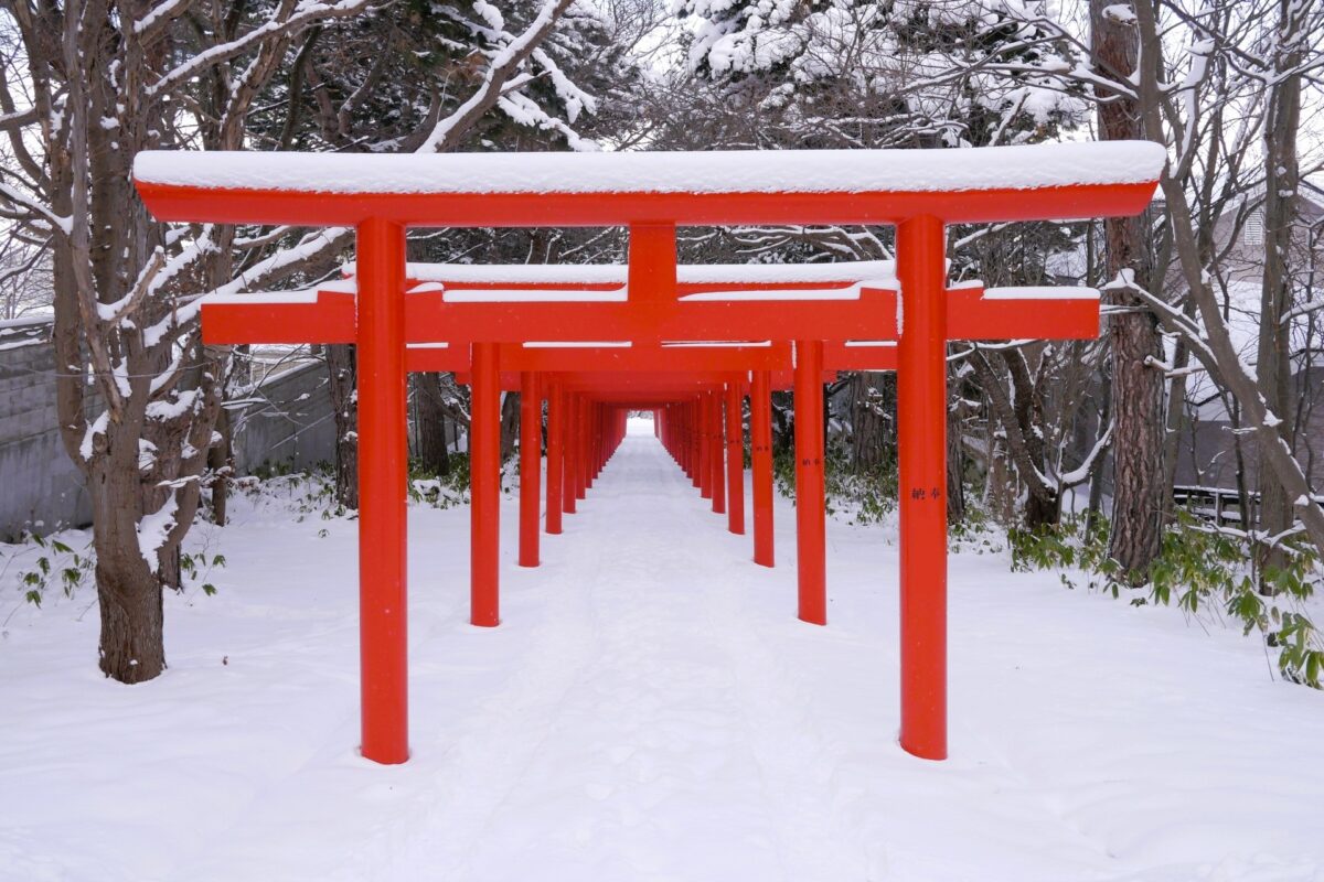 Sapporo Fushimi Inari Shrine covered in snow, surrounded by winter scenery