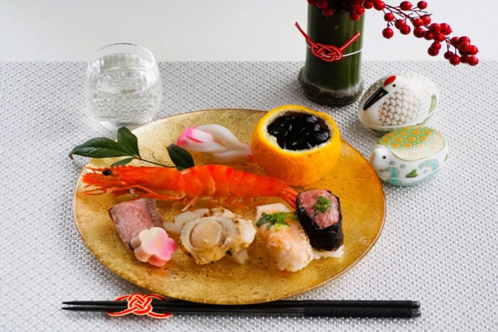 Traditional Japanese osechi dishes with nandina (sacred bamboo) flower arrangement