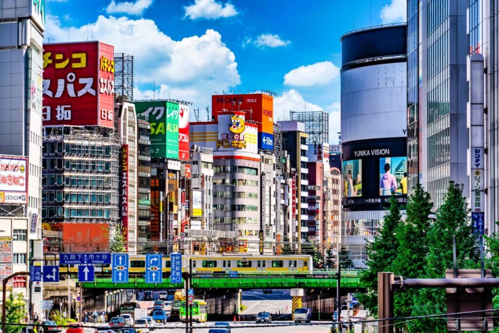 Urban streets around Shinjuku O-Guard area beneath elevated railway tracks