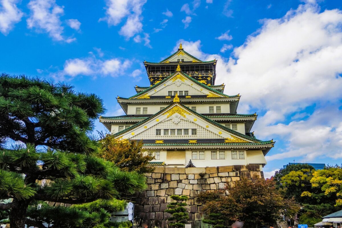 Osaka Castle, a famous Japanese landmark surrounded by stone walls and greenery