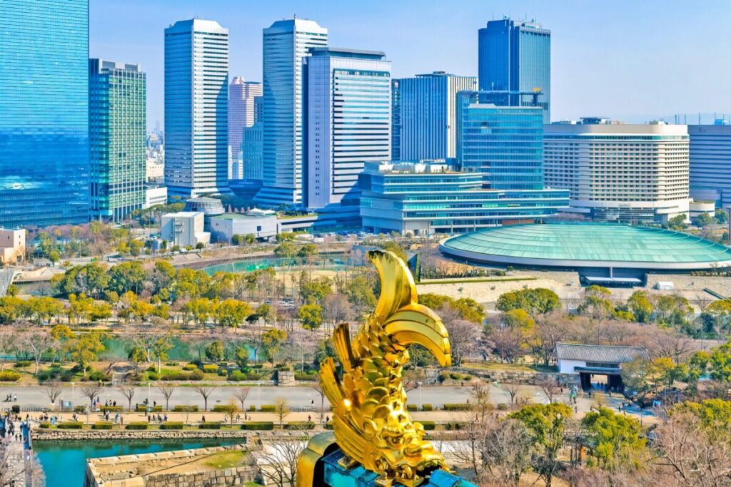 View of Osaka Castle Park and city skyline seen from the golden shachihoko