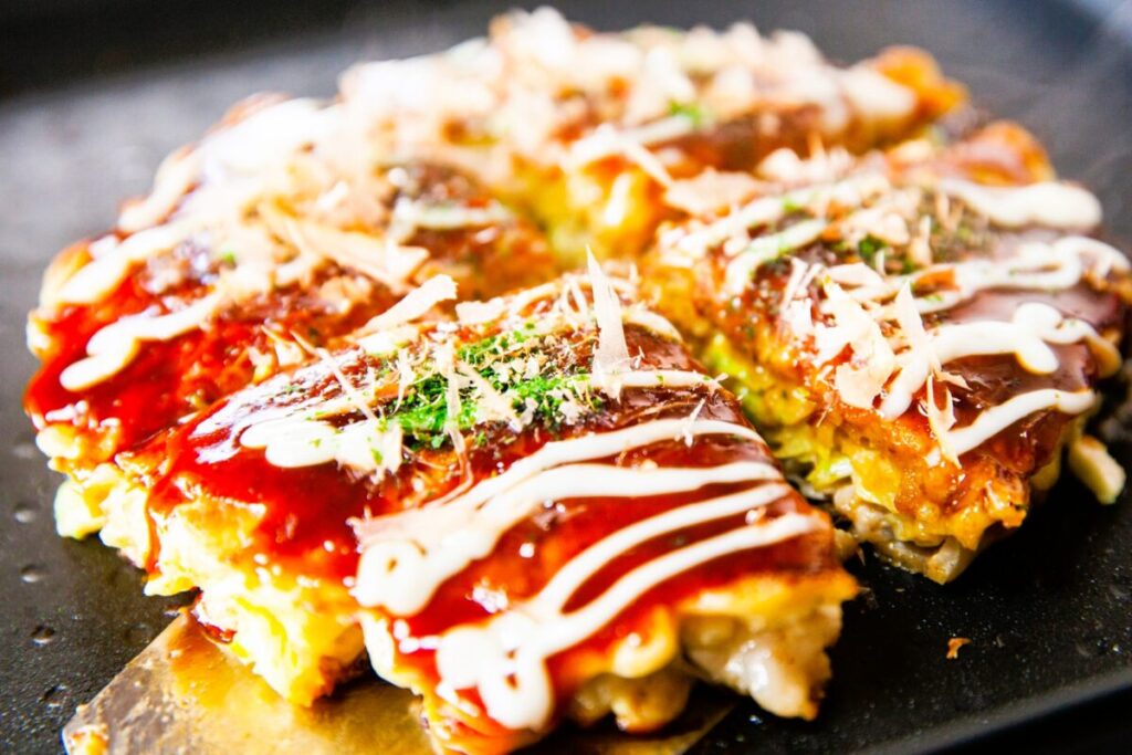 Osaka-style okonomiyaki savory pancake with cabbage and toppings
