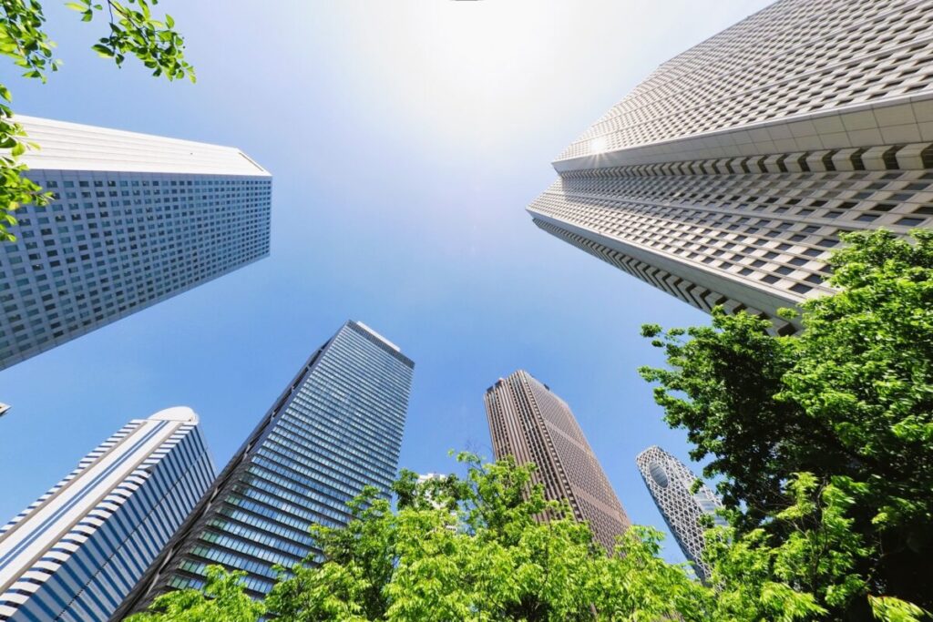 Modern skyscrapers under a bright blue sky with sunshine in Japan