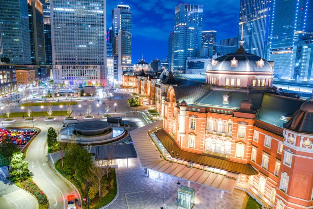 Tokyo Station illuminated at night with surrounding city lights