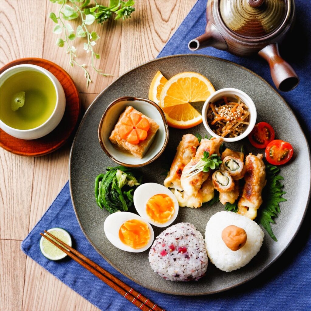 Traditional Japanese meal plate with rice fish vegetables and side dishes