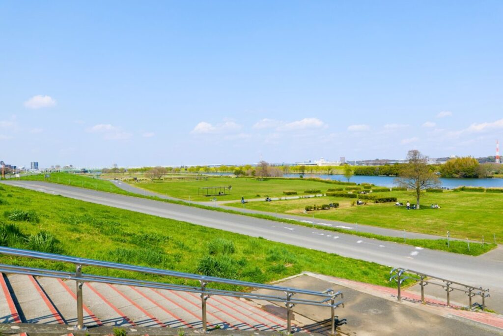 Edogawa riverside park in Tokyo Japan, wide riverbank with walking and cycling paths