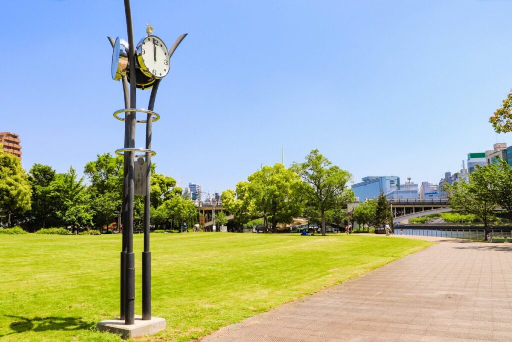 Nakanoshima Park in Osaka Japan, riverside park with city skyline and greenery