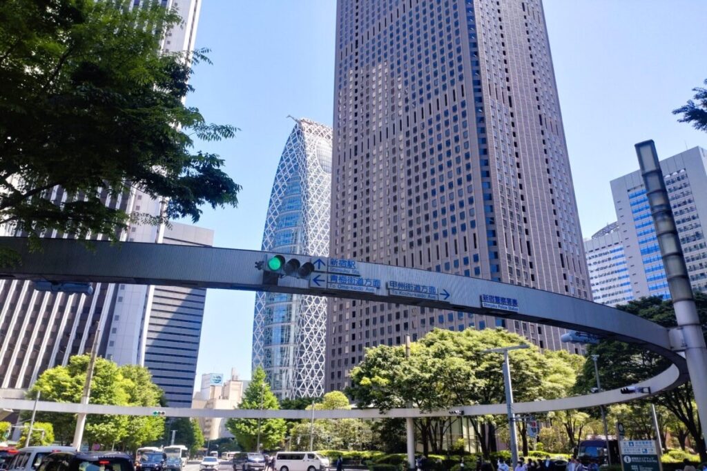 Street intersection in Nishi Shinjuku Tokyo, modern city buildings and traffic scenery