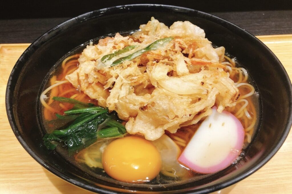 Tempura soba Japanese noodle dish with crispy shrimp tempura and buckwheat noodles